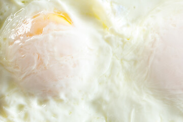 A top down view of eggs over easy, as a background.