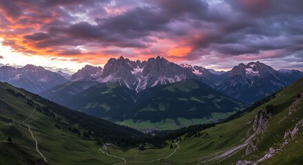 Dramatic sunset over rugged mountain range with vibrant colors and landscape