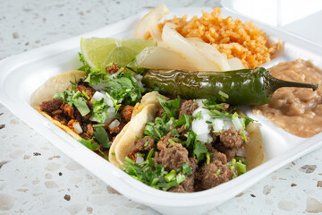 A view of a street taco combo plate.