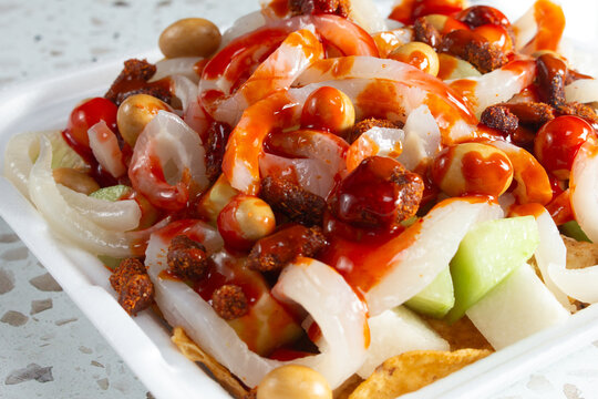 A closeup view of a container of tostilocos.