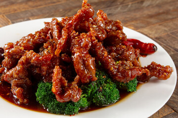 A view of a plate of orange beef.