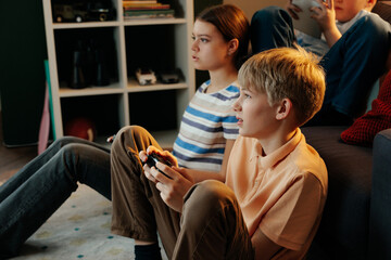 Generation z children playing video games at home