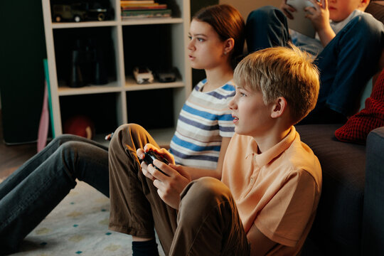 Generation z children playing video games at home