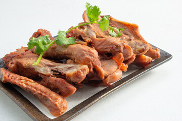 A view of a plate of chopped duck wings.