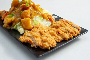 A view of a plate of curry chicken rice.