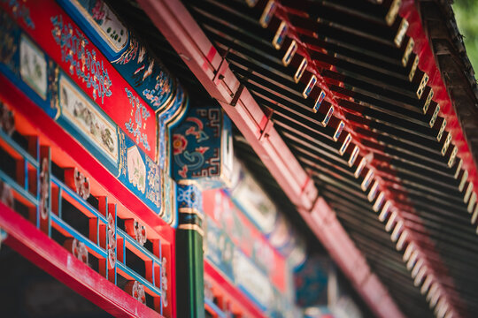 Intricate, vibrant red and gold latticework adorns the ceiling of a Beijing palace, showcasing symmetrical patterns within the Prince Kung's Palace Museum. - Powered by Adobe