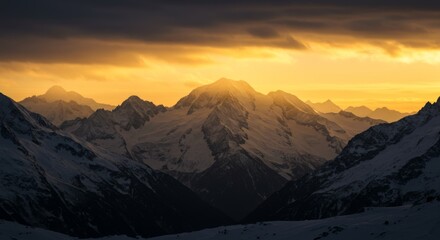 Snowy peaks bathed in golden sunset light