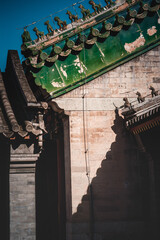 Ornate, stone dragon sculptures adorn the roof of the Beijing Prince Kung's Palace Museum,...
