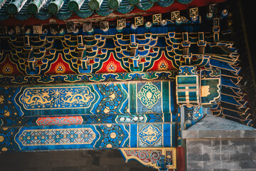 The ornate, tiled roof of the Prince Kung's Palace Museum in Beijing exhibits intricate symmetrical...