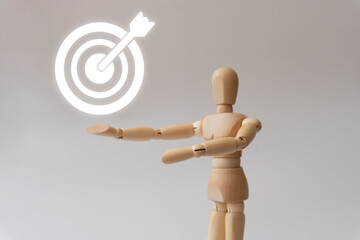 Wooden mannequin showing a target icon