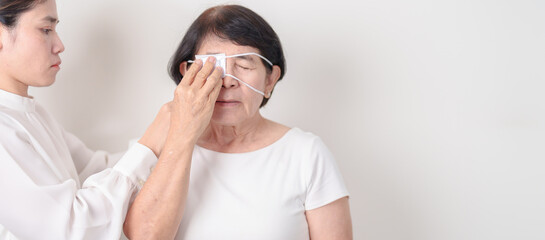 Elderly Woman with Eye protecting by Eye Pad for concepts of Eye disease, Cataract, Glaucoma, Age...