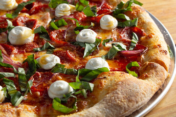 A closeup view of a rustic pepperoni ricotta pizza.