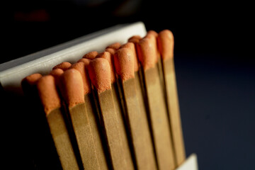 Flat wooden matchbook with orange heads matchsticks