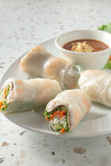 A view of a plate of shrimp pork spring rolls.