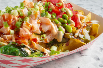 A closeup view of a tray of poke nachos.