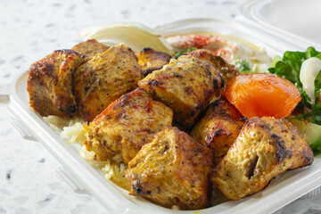 A closeup view of a chicken kebab plate.