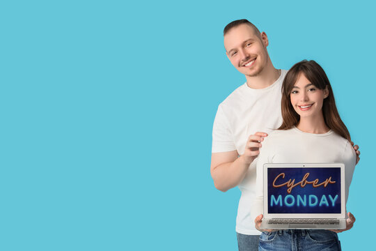 Young couple with laptop on blue background. Cyber Monday - Powered by Adobe