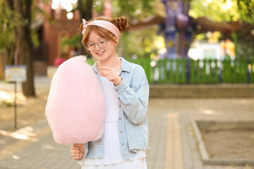 Teen girl with cotton candy in park