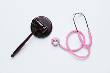 Judge gavel with stethoscope on white background. Concept of health care reform