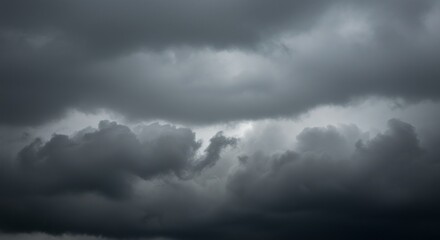 Obraz premium Dark, ominous storm clouds gathering in a dramatic, overcast sky before rainfall.