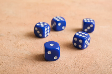 Blue dices on beige background