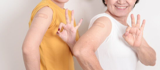 Adult and Elderly Woman with bandage after received vaccine. Vaccination and Immunization for Influenza, HPV, Zoster, IPD, DTP, Dengue, Encephalitis, Rabies, Pneumococcal Hepatitis B and Covid vaccine