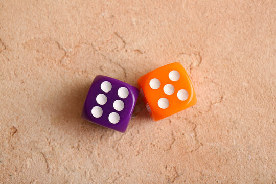 Different dices on beige background