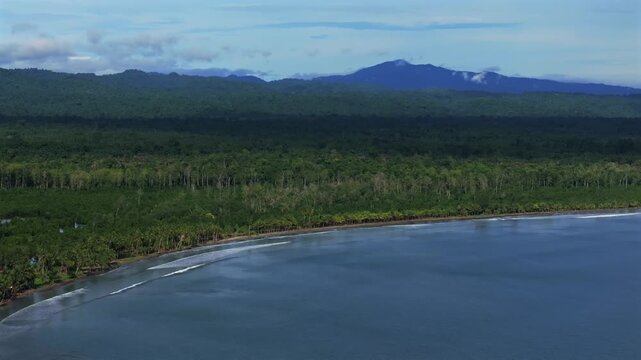 Wewak waves sea harbour view Wewak Hill Cape Wom Dogreto aerial drone Papua New Guinea Pacific Ocean pristine remote tropical beach coastline sunny dry season blue sky morning mountains forward pan up