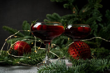 Cocktail based on gin with cranberry juice in christmas decorations. Cocktails for christmas party. 
