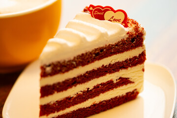Homemade cake Red Velvet decorated with cream and cup of coffee