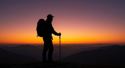 Silhouette of hiker with backpack against sunset sky over mountain range