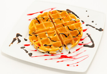 waffle with chocolate and raspberry syrup