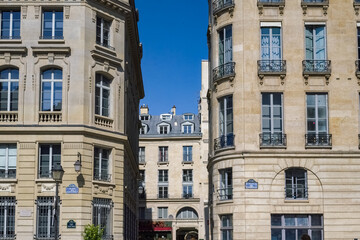 Fototapeta premium Paris, beautiful buildings, place des Petits-Peres, in the 2e arrondissement, blue sky 