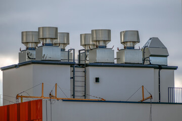 Exhaust ventilation equipment on the roof of a house on an autumn day