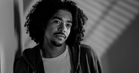 Black and white portrait of young african american male model posing in studio photoshooting with...
