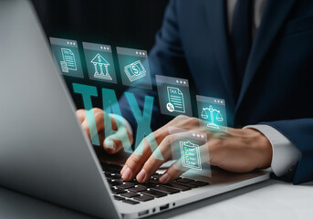 Digital Tax Filing and Financial Compliance Interface, Laptop shows glowing TAX icon with legal and financial symbols