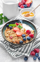 Granola bowl with yogurt, berries, and mint for breakfast