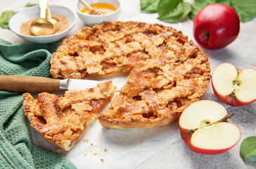 Homemade apple pie with ingredients on concrete background