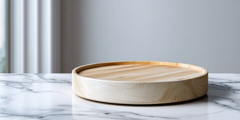 A round serving board with a slightly raised edge on a clean white wooden counter. The background is a bright, pure white blur