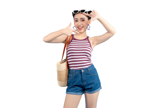 Portrait of a stylish young Asian woman posing with a hand gesture. She is wearing sunglasses, a striped top, and denim shorts, holding a bag on PNG - Powered by Adobe