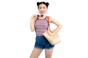 Portrait of a young Asian woman smiling and posing with her sunglasses. She is wearing a tank top and denim shorts, carrying a handbag.