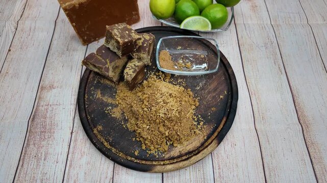 focused view of hands in action, meticulously grating panela into fine grains for a wholesome and natural beverage