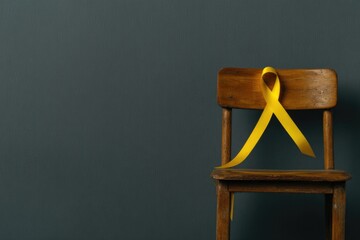 Wooden chair adorned with bright yellow ribbon symbolizing anti-