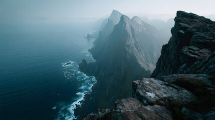 Rocky Cliff Edge Overlooking Expansive Ocean Under Pale Sky