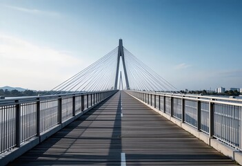Obraz premium Modern pedestrian cable-stayed bridge under blue sky