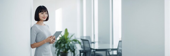 Young woman with potted plant by window in natural light modern interior