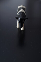 A miniature figure of a domestic black and white cow that irresistibly reminds of the village and childhood and the taste of fresh domestic milk