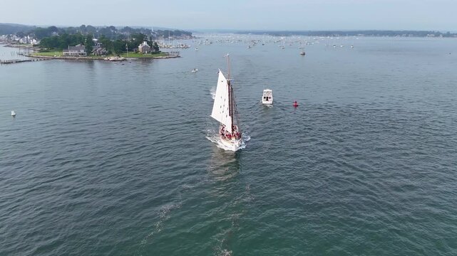 Aerial view of boats sailing on the water near islands, creating a dynamic scene of maritime activity and scenic beauty, Mystic, Connecticut, United States.
