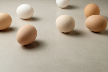Variety of eggs arranged artistically on a clean surface in natural light