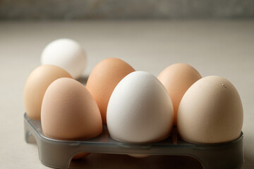 Fresh eggs arranged neatly in an egg carton on a kitchen counter